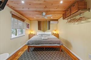 a bedroom with a bed and a ceiling fan at Pocono Scandinavian Cottage in Tobyhanna +55 photos
