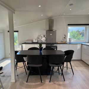 a kitchen with a table and chairs in a room at Leilighet i Stamsund, Lofoten in Rishaugen +19 photos