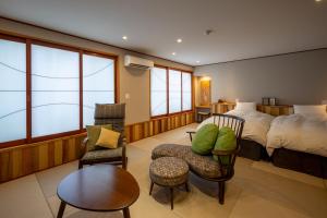 a bedroom with a bed and a table and chairs at Ryokan Asunaro in Takayama +113 photos