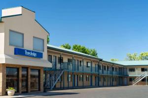 a building with a blue sign on the side of it at Travelodge by Wyndham Wall in Wall