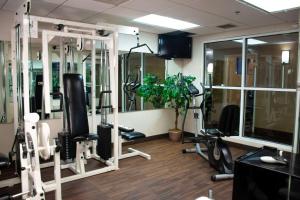 a gym with several treadmills and machines in a room at Comfort Inn in Dickson