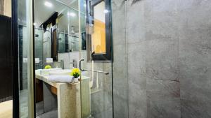 a bathroom with a sink and a shower at BluO Studio - M Block Mkt Greater Kailash in New Delhi