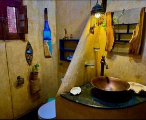a bathroom with a copper sink and a toilet at Villa Andalusia Dahab blue in Dahab