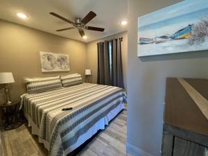 a bedroom with a bed and a ceiling fan at Forever Sunshine - Beach Vacation Rental in Clearwater Beach +32 photos
