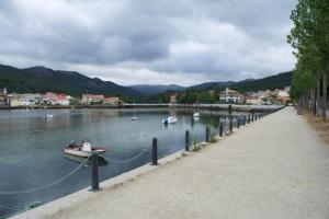 a boat is chained to a dock on a lake at Pensión Casa de Casiano en Esteiro in Muros