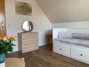 a bedroom with a bed and a mirror and a table at K&O Penzenstadler in Alt Bukow +14 photos