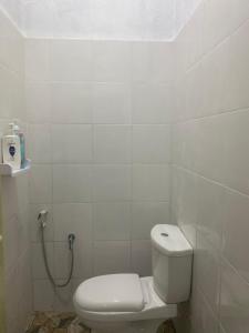 a white bathroom with a toilet and a shower at Homestay Kita in Kuala Terengganu +15 photos