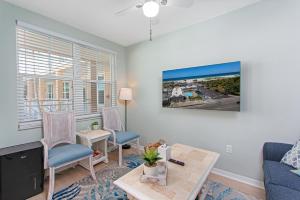 a living room with a couch and a table at Clearwater Beach Suites #106 in Clearwater Beach