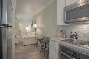 a kitchen with a stove and a counter top at Clearwater Beach Suites #105 in Clearwater Beach