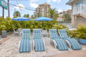 a group of chairs and umbrellas on a patio at Clearwater Beach Suites #105 in Clearwater Beach