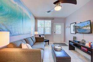a living room with a couch and a tv at Clearwater Beach Suites #104 in Clearwater Beach