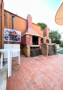 a brick patio with a pizza oven in front of a building at Karma Rural Buenavista in Santa Marinella
