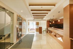 a large kitchen with a long hallway with a dining room at Super Townhouse Edasserys Kalamassery Tourist Home in Cochin