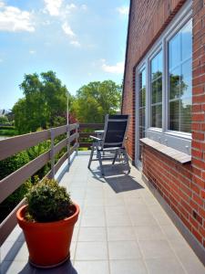 a patio with a chair on a balcony at Ferienwohnung-Seerose in Bojendorf
