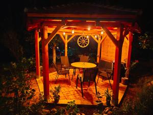 a wooden pergola with a table and chairs on a patio at Soko-Veljkovic-apartman in Soko Banja