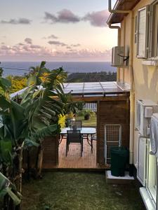a view from the balcony of a house with a table at O Soleya in Saint-Joseph