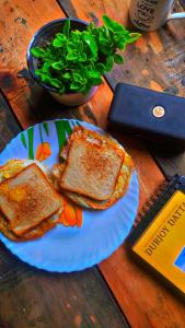 a plate with two pieces of toast on a table at Canvas and Coffee in Kasol