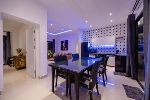 a dining table and chairs in a living room at Thala Villa Koh Samui in Nathon Bay