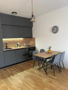 a kitchen with a table and chairs in a room at Montenegro Suite Rental in Bar