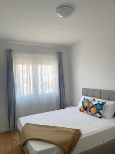 a bedroom with a large bed with a window at Montenegro Suite Rental in Bar