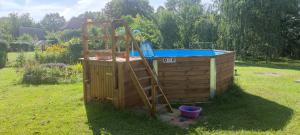 a ladder is next to a hot tub next to a wooden deck at Ferienwohnung Marienkäfer in Wulkow