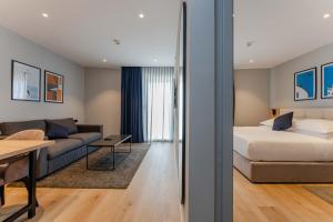 a hotel room with a bed and a couch at Hotel A'mare in Zadar