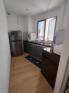 a kitchen with a refrigerator and a counter top at CJ Cozy House 5 Mins Walk to Jonker Street in Melaka