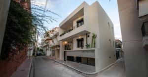 a large white building on a city street at Asklipiou Cube - Kalamata Mediterranean Suites in Kalamata