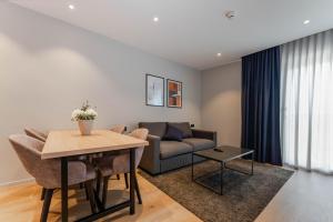 a living room with a couch and a table at Hotel A'mare in Zadar