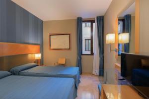 เตียงในห้องที่ Hotel del Mar