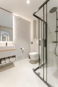 a bathroom with a shower and a toilet and a sink at Hotel A'mare in Zadar