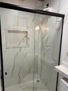 a shower with a glass door in a bathroom at Casa Essence - loftsparaíso in Luis Eduardo Magalhaes