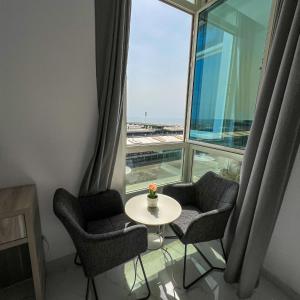 a room with a table and chairs and a window at The Red Sea Apartment شقة البحر الأحمر in Jeddah