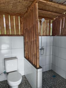 a bathroom with a toilet and a shower at Dewi Rinjani Homestay in Tetebatu +68 photos