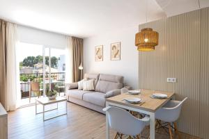 a living room with a table and a couch at Martinez Apartments in Palmanova