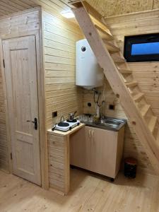 a kitchen with a sink in a wooden cabin at Zovaber hangsti goti in Sevan +31 photos