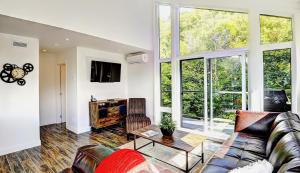 a living room with a couch and a table at Chalet 23 Chemin des Quarante by Les Chalets Alpins in Stoneham