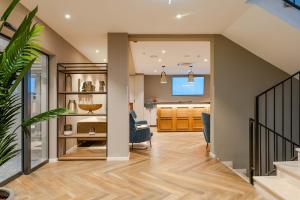 a home office with a staircase and a living room at Hotel A'mare in Zadar