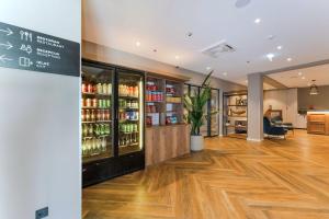 a restaurant with a drink cooler in a room at Hotel A'mare in Zadar