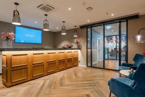a lobby with a waiting area with a flat screen tv at Hotel A'mare in Zadar