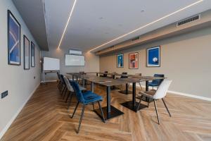a conference room with a long table and chairs at Hotel A'mare in Zadar