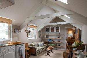 a kitchen and living room with an attic at Zen Den Cornwall in Boscastle