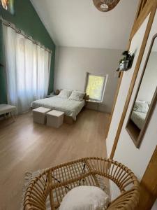 a bedroom with a bed and a chair in it at Chambre d hôte en Drôme des collines pour 2 à 4 personnes in Saint-Laurent-dʼOnay