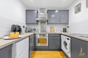 a kitchen with stainless steel appliances and a plate of food at 2 Bedroom Greek Street Apartment - Sleeps 6 in Leeds +19 photos