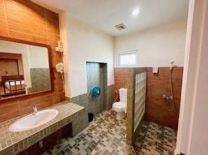 a bathroom with a sink and a toilet at Suan Palm Garden View in Rayong +19 photos