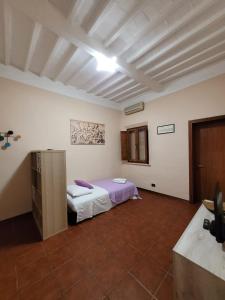 Postel nebo postele na pokoji v ubytování L'antica dimora Torre di Cascina