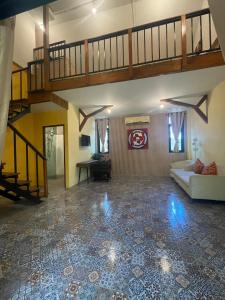 a large living room with a staircase and a couch at Baibon2 Homestay Thalang Phuket in Thalang