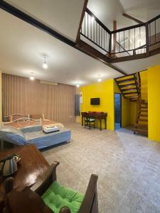 a large room with a bed and a staircase at Baibon2 Homestay Thalang Phuket in Thalang
