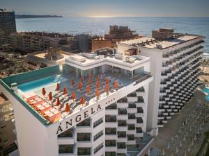 an apartment building with a swimming pool and the ocean at Hotel Angela - Adults Recommended in Fuengirola