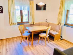 a living room with a table and chairs and a couch at Gästehaus Schwed in Wagrain